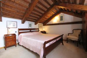 ein Schlafzimmer mit einem großen Bett und einem Stuhl in der Unterkunft Zoia Terrace view on St Marks Basilica 150mt in Venedig + 8 Fotos