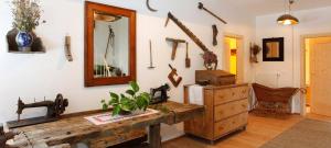 a room with a wooden table and a mirror at Baumannhof Mooskofel - adults only in Plazzoles