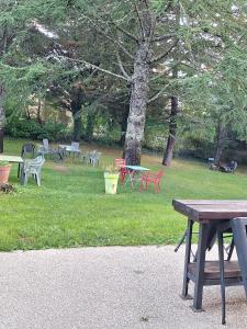 a group of picnic tables in a park at Chambres d'hôtes LA CHAPELAINE in La Chapelle-en-Vercors