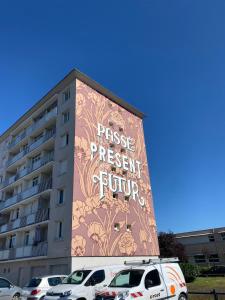 a building with a mural on the side of it at Rive Lumière near canal and city center in Montargis