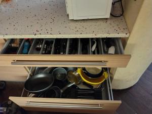 a drawer filled with lots of pots and pans at Appartamento Sleep&Fly in Grassobbio +16 photos