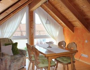 a dining room with a wooden table and chairs at Ferienwohnung Wühn in Teisendorf