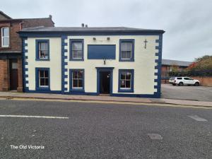 a blue and white building on the side of a street at The Old Victoria in Penrith