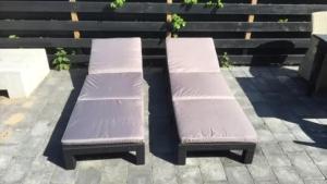 two benches sitting next to each other on a sidewalk at Chalet 218 in Petten +9 photos