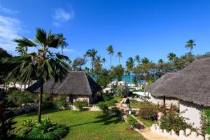 a view of a resort with thatched roofs and palm trees at Diamonds Mapenzi Beach in Kiwengwa