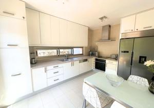 a kitchen with white cabinets and a green refrigerator at Villa Calma Tauro, Golf, Beach and Relax in La Playa de Tauro