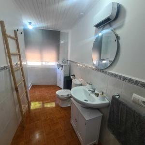 a bathroom with a sink and a toilet and a mirror at Villa Mallorquina tu zona para desconectar in Jacébanes +66 photos