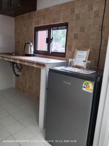 a kitchen with a dishwasher and a counter top at The pool villa in Ban Phu Din