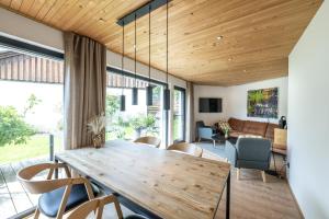 a dining room with a wooden table and chairs at Hochwertige Alpenchalets Allgäu in Immenstadt im Allgäu