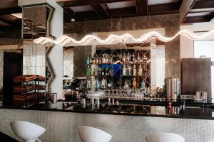 a bar with a black counter and some drinks at Mounthree in Pʼambak
