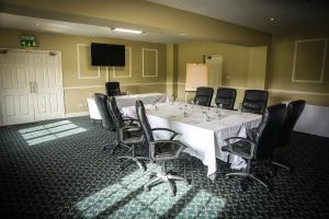 a conference room with a white table and black chairs at Springfort Hall Hotel in Mallow