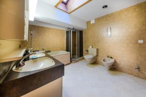 a bathroom with a sink and a toilet at Poschiavo Suisse Hotel in Poschiavo +107 photos