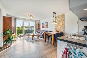 a kitchen and living room with a couch and a table at Kleine Auszeit - Hohe Lith in Cuxhaven