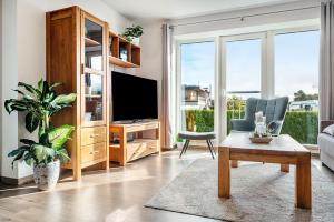 a living room with a tv and a couch at Kleine Auszeit - Hohe Lith in Cuxhaven
