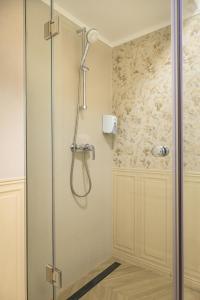 a shower with a glass door in a bathroom at Pensiunea Casa Sturza in Bacău +97 photos