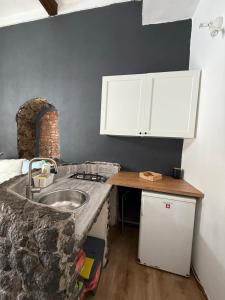 a kitchen with a sink and a counter top at Gesuiti Home - Lumina Collection in Catania
