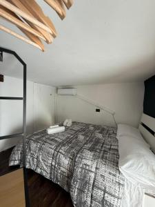 a bedroom with a bed in a room at Gesuiti Home - Lumina Collection in Catania