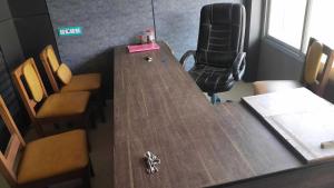 a conference room with a long wooden table and chairs at HOTEL O AWARA GRAND PALACE in Pratāpgarh