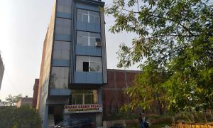 a building with a sign on the side of it at HOTEL O AWARA GRAND PALACE in Pratāpgarh