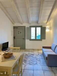 a living room with a table and a couch at Tenuta Paltusa in Calangianus
