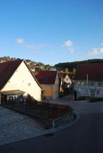 a small town with houses and a fence in a street at Ruhiges Apartment in Weissach - Nähe Porsche in Weissach +3 photos