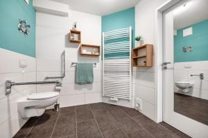 a bathroom with a toilet and a sink at Kleine Auszeit - Hohe Lith in Cuxhaven +23 photos