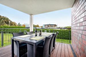 a dining table on a deck with a view at Kleine Auszeit - Hohe Lith in Cuxhaven