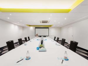 a conference room with a long table and chairs at Mantra on Northbourne in Canberra