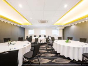 a conference room with white tables and chairs at Mantra on Northbourne in Canberra +92 photos