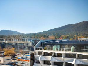 an aerial view of a building with mountains in the background at Mantra on Northbourne in Canberra +95 photos