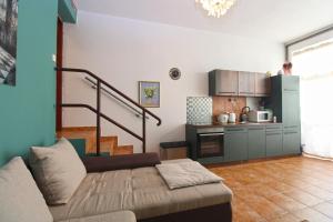 a living room with a couch and a kitchen at Apartments Kada 1571 in Pula