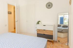 a bedroom with a bed and a dresser at Bosmar 1C in Pals