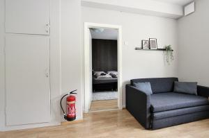 a living room with a couch and a bedroom at LL Properties - H99 Main Street Stay in Akureyri