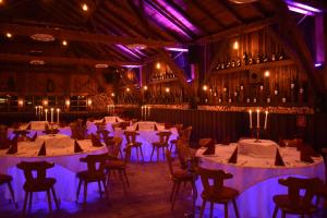 a dining room with tables and chairs and wine bottles at Beim Krahwirt in Deggendorf