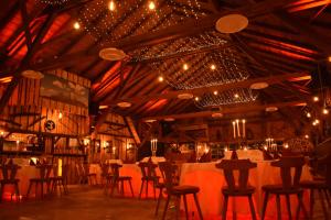 a dining room with tables and chairs and lights at Beim Krahwirt in Deggendorf