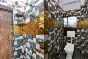 a bathroom with a toilet and a mosaic wall at Hotel O Lila Guest House in Sāntrāgāchi