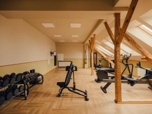 a gym with treadmills and exercise equipment in a building at Flaner Hotel, WorldHotels Crafted in Warsaw