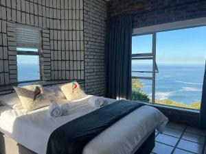 a bedroom with a bed with a view of the ocean at Blue Whale Resort in George