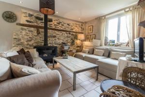 a living room with a couch and a fireplace at La demeure de zoé in Castelbiague