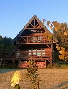 a large wooden building with a roof at Domek w górach Łubinowa 6 in Międzylesie