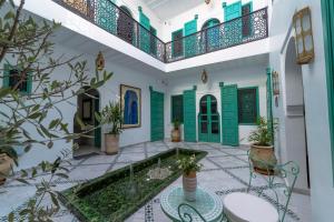 a courtyard with a pool in a house at Riad Nejma Benyoussef in Marrakesh