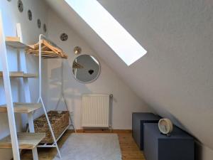 a attic room with a ladder and a bunk bed at Ferienwohnung Boven in Timmel