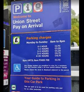 a sign for a parking meter at a parking garage at Stylish Flat on Cowley a Walk to Oxford Centre in Oxford +15 photos