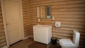 a bathroom with a toilet and a mirror and a phone at Jansaya Resort база отдыха Жансая in Aleksandrovka +25 photos