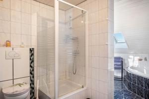 a bathroom with a shower and a toilet and a sink at fewo-wosink in Bad Krozingen +19 photos