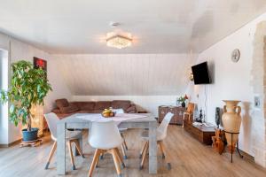 a living room with a table and chairs and a couch at fewo-wosink in Bad Krozingen
