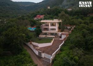 an aerial view of a house in the mountains at StayVista at Anandam Lake Villa - Khadakwasla in Pune