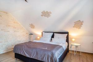 a bedroom with a large bed in a attic at fewo-wosink in Bad Krozingen