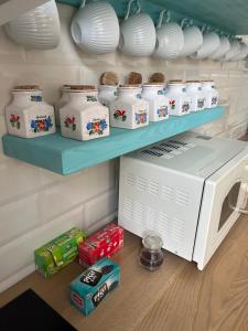 a microwave sitting on a shelf next to some food at Apartmány Naxarův dvůr in Horažďovice