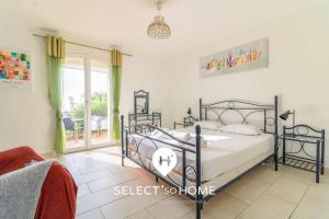 a bedroom with a bed and a large window at SELECT'soHOME - Magnifique villa pour 10 personnes avec piscine à débordement et vue sur la mer ! - VILLA PAVILLOU in Le Lavandou +11 photos